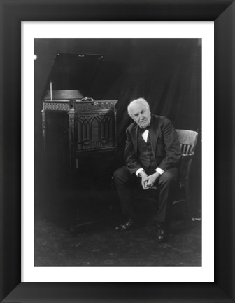 Framed Thomas Edison, seated beside phonograph Print