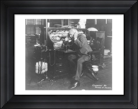 Framed Thomas Alva Edison using his dicatating machine Print