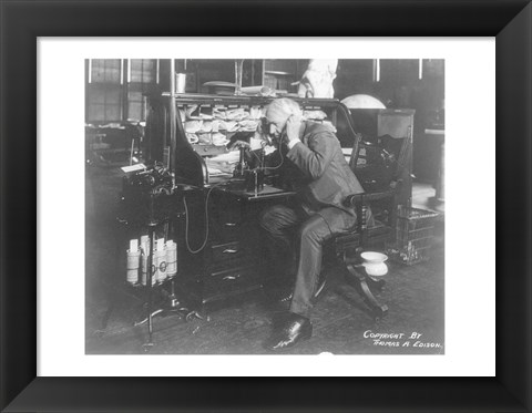 Framed Thomas Alva Edison using his dicatating machine Print