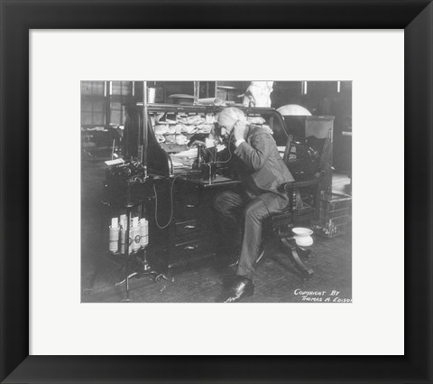Framed Thomas Alva Edison using his dicatating machine Print