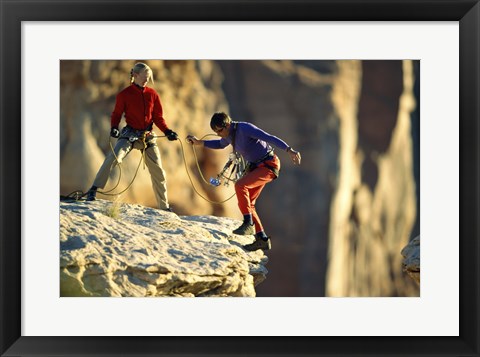 Framed Two hikers with ropes at the edge of a cliff Print