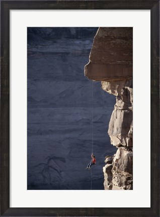 Framed Man hanging from a rope on the edge of a cliff Print
