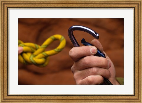 Framed Close-up of human hands holding a carabiner and rope Print