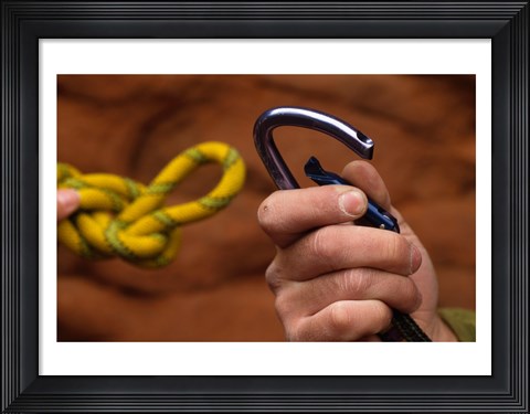 Framed Close-up of human hands holding a carabiner and rope Print