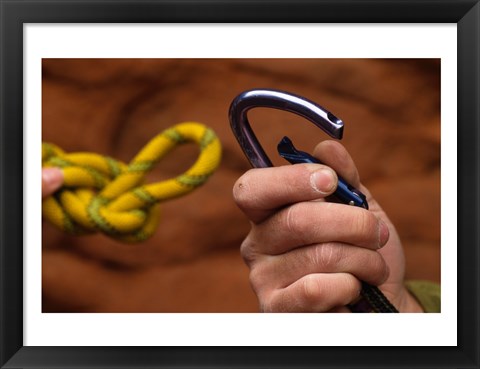 Framed Close-up of human hands holding a carabiner and rope Print