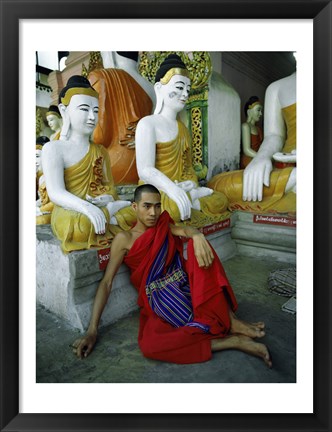 Framed Monk Sitting in Front of a Buddha Statue Print