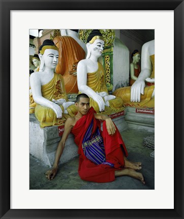 Framed Monk Sitting in Front of a Buddha Statue Print