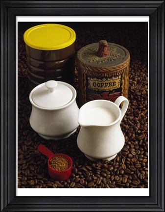Framed Close-up of a mug of milk with a measuring spoon and jars on coffee beans Print