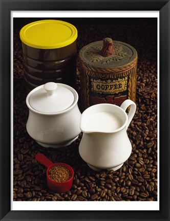 Framed Close-up of a mug of milk with a measuring spoon and jars on coffee beans Print