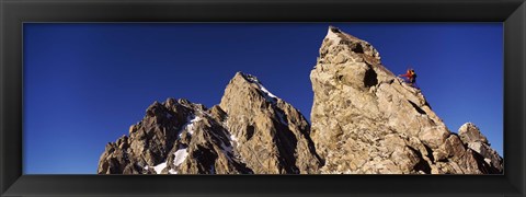 Framed Low angle view of a man climbing up a mountain, Rockchuck Peak, Grand Teton National Park, Wyoming, USA Print