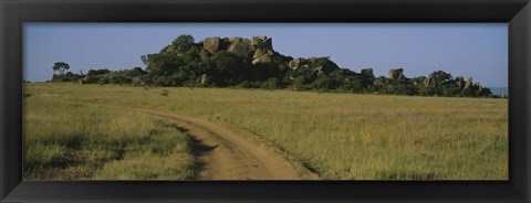 Framed Road passing through a grassland, Simba Kopjes, Road Serengeti, Tanzania, Africa Print