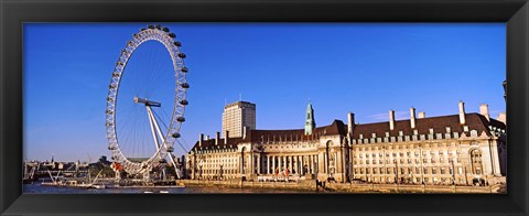 Framed Ferris wheel with buildings at the waterfront, River Thames, Millennium Wheel, London County Hall, London, England Print