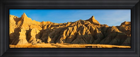Framed Sculpted sandstone spires in golden light, Saddle Pass Trail, Badlands National Park, South Dakota, USA Print