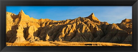 Framed Sculpted sandstone spires in golden light, Saddle Pass Trail, Badlands National Park, South Dakota, USA Print