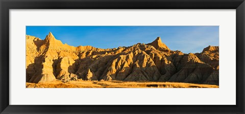 Framed Sculpted sandstone spires in golden light, Saddle Pass Trail, Badlands National Park, South Dakota, USA Print