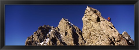 Framed Low angle view of a man climbing up a mountain, Rockchuck Peak, Grand Teton National Park, Wyoming, USA Print