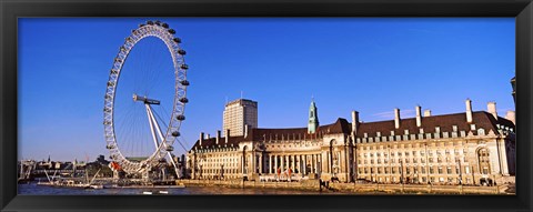 Framed Ferris wheel with buildings at the waterfront, River Thames, Millennium Wheel, London County Hall, London, England Print