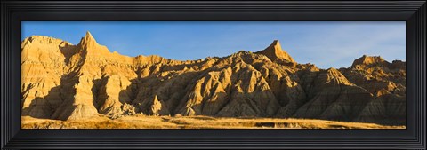 Framed Sculpted sandstone spires in golden light, Saddle Pass Trail, Badlands National Park, South Dakota, USA Print