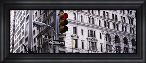 Framed Low angle view of a Red traffic light in front of a building, Wall Street, New York City Print