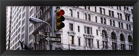 Framed Low angle view of a Red traffic light in front of a building, Wall Street, New York City Print