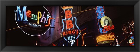 Framed Low angle view of neon signs lit up at night, Beale Street, Memphis, Tennessee, USA Print