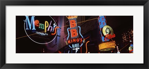 Framed Low angle view of neon signs lit up at night, Beale Street, Memphis, Tennessee, USA Print