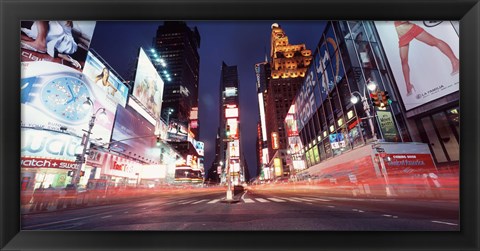 Framed Low angle view of sign boards lit up at night, Times Square, New York City, New York, USA Print