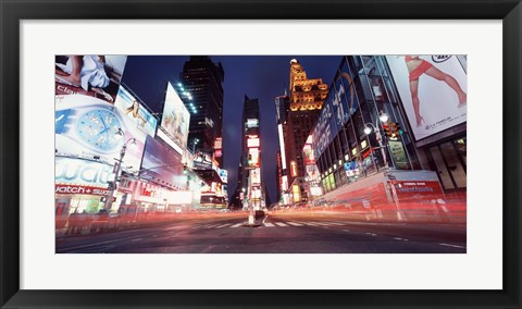 Framed Low angle view of sign boards lit up at night, Times Square, New York City, New York, USA Print