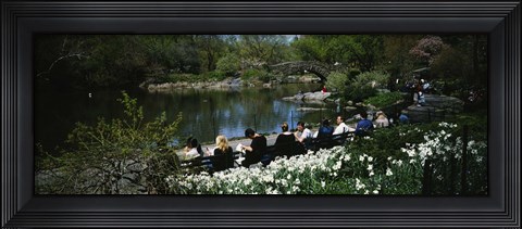 Framed Group of people sitting on benches near a pond, Central Park, Manhattan, New York City, New York State, USA Print