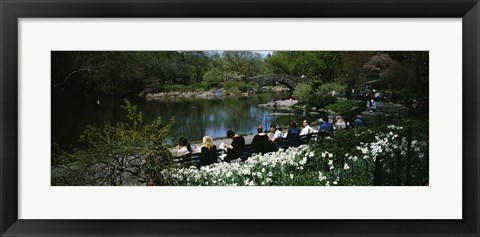 Framed Group of people sitting on benches near a pond, Central Park, Manhattan, New York City, New York State, USA Print