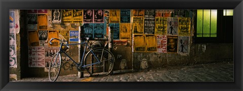 Framed Bicycle leaning against a wall with posters in an alley, Post Alley, Seattle, Washington State, USA Print