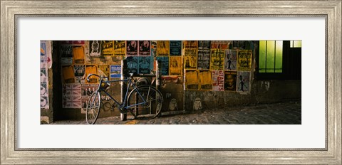 Framed Bicycle leaning against a wall with posters in an alley, Post Alley, Seattle, Washington State, USA Print