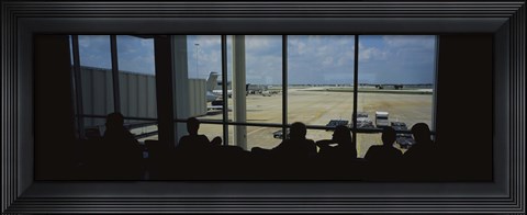 Framed Silhouette of a group of people at an airport lounge, Orlando International Airport, Orlando, Florida, USA Print