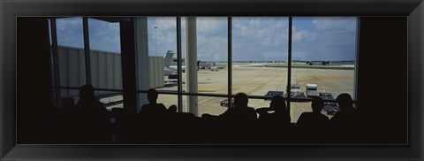 Framed Silhouette of a group of people at an airport lounge, Orlando International Airport, Orlando, Florida, USA Print