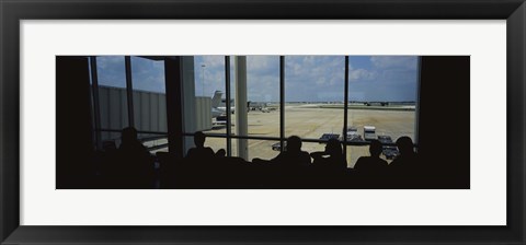 Framed Silhouette of a group of people at an airport lounge, Orlando International Airport, Orlando, Florida, USA Print