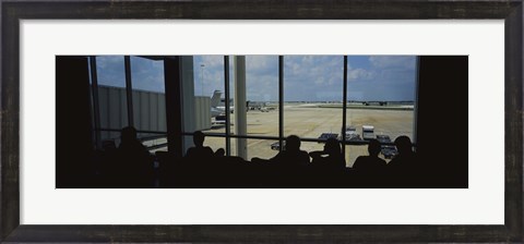 Framed Silhouette of a group of people at an airport lounge, Orlando International Airport, Orlando, Florida, USA Print