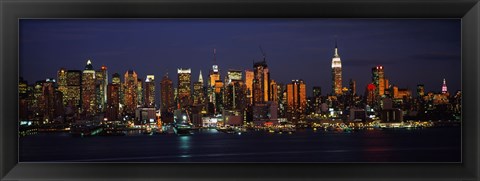 Framed Skyscrapers lit up at night in a city, Manhattan, New York City, New York State, USA Print