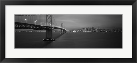 Framed Low angle view of a suspension bridge lit up at night, Bay Bridge, San Francisco, California, USA Print