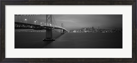 Framed Low angle view of a suspension bridge lit up at night, Bay Bridge, San Francisco, California, USA Print