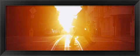 Framed Side profile of a person crossing the cable car tracks at sunset, San Francisco, California, USA Print