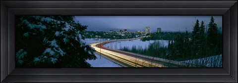 Framed Autumobile lights on busy street, distant city lights, frozen Westchester Lagoon, Anchorage, Alaska, USA. Print