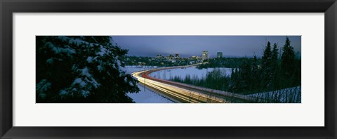 Framed Autumobile lights on busy street, distant city lights, frozen Westchester Lagoon, Anchorage, Alaska, USA. Print