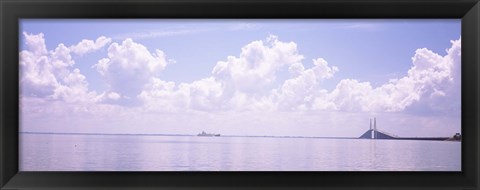 Framed Sea with a container ship and a suspension bridge in distant, Sunshine Skyway Bridge, Tampa Bay, Gulf of Mexico, Florida, USA Print