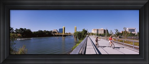 Framed Bicyclists along the Sacramento River with Tower Bridge in background, Sacramento, Sacramento County, California, USA Print