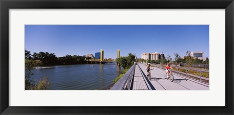 Framed Bicyclists along the Sacramento River with Tower Bridge in background, Sacramento, Sacramento County, California, USA Print