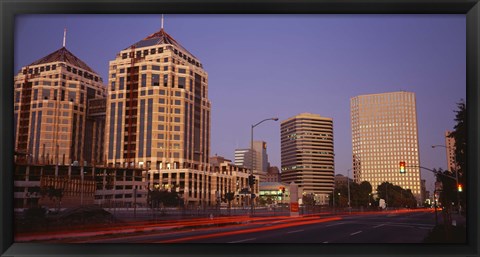 Framed USA, California, Oakland, Alameda County, New City Center, Buildings lit up at night Print