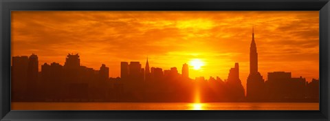 Framed Birght Orange Sky and Sun Behind the New York City Skyline Print