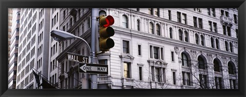 Framed Low angle view of a Red traffic light in front of a building, Wall Street, New York City Print