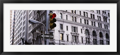 Framed Low angle view of a Red traffic light in front of a building, Wall Street, New York City Print