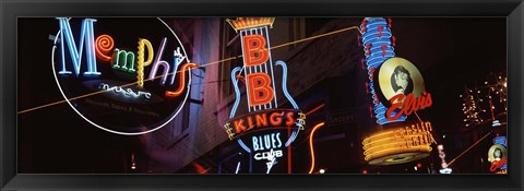Framed Low angle view of neon signs lit up at night, Beale Street, Memphis, Tennessee, USA Print